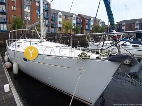 Beneteau Oceanis 411 Clipper: bow view afloat at a pontoon in Swansea Marina with brick flats behind