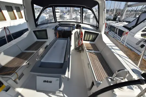 Beneteau Oceanis 42.1: cockpit looking forward with central table, teak seat panels and sprayhood