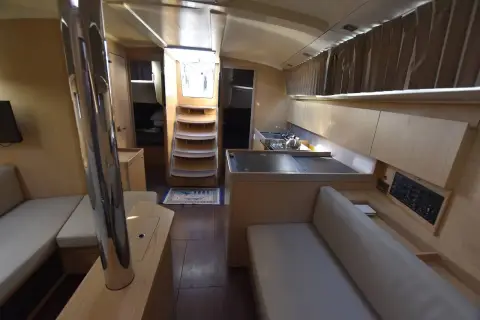 Beneteau Oceanis 42.1: saloon looking aft to the companionway steps, galley island and wood-toned joinery