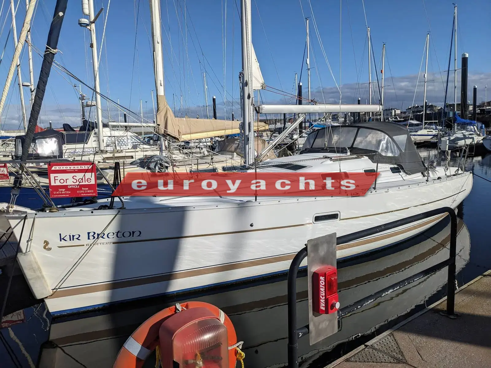 Beneteau Oceanis Clipper 323: starboard side of the white hull moored stern-to in a marina under blue sky