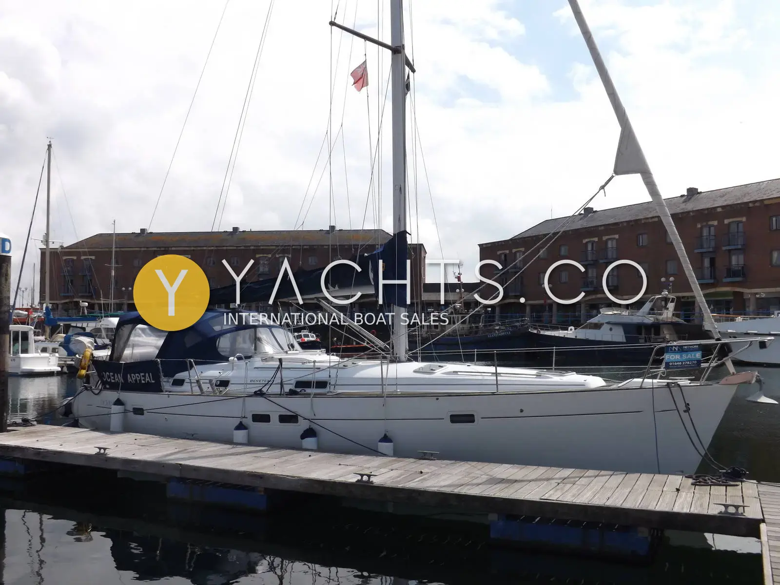Beneteau Oceanis Clipper 411: white sloop moored stern-in at a pontoon with brick warehouse buildings behind