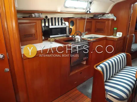 Beneteau Oceanis Clipper 411: galley with microwave, oven, twin sinks and varnished wooden cabinetry