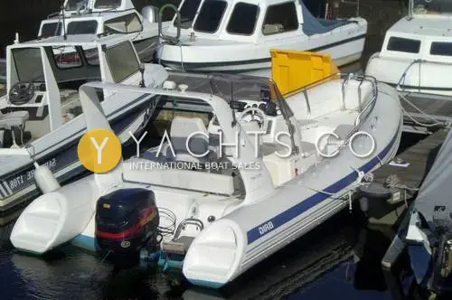Brig 600 Eagle: stern quarter view afloat showing Evinrude outboard, console seating and radar arch in marina