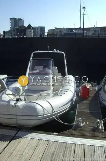 Brig 600 Eagle: bow-on view berthed at marina pontoon with waterfront buildings behind