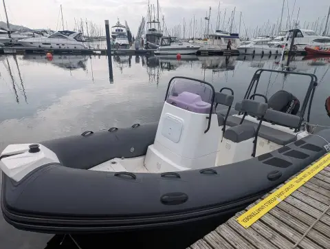 Brig RIBs Navigator 520: centre console with purple seat cushion and grey tubes, afloat in a busy marina