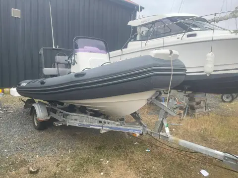 Brig RIBs Navigator 520: hull and grey tubes on a galvanised road trailer, stored ashore in a boatyard