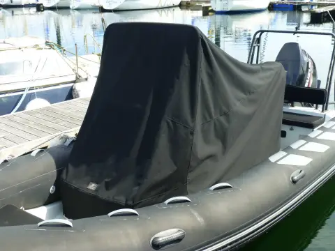 Brig RIBs Navigator 610: dark fitted cover over the console and seating, with grey tubes and rubbing strake