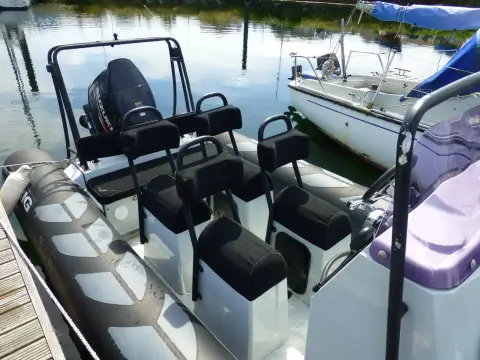 Brig RIBs Navigator 610: rows of black jockey seats behind the console, with arch and outboard at the stern