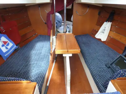 Cornish Crabber 22 Gaff Cutter: main cabin with blue patterned bench seats either side of the folded wooden table