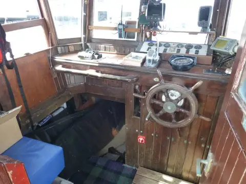 Custom Built John Gaff 8.25 Fishing Boat: varnished wheelhouse interior with wooden wheel, instruments and steps down to the cabin