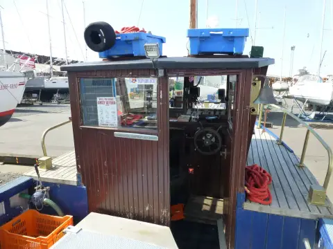 Custom Built John Gaff 8.25 Fishing Boat: wheelhouse rear door from the cockpit, with storage boxes and lifebuoy on the roof