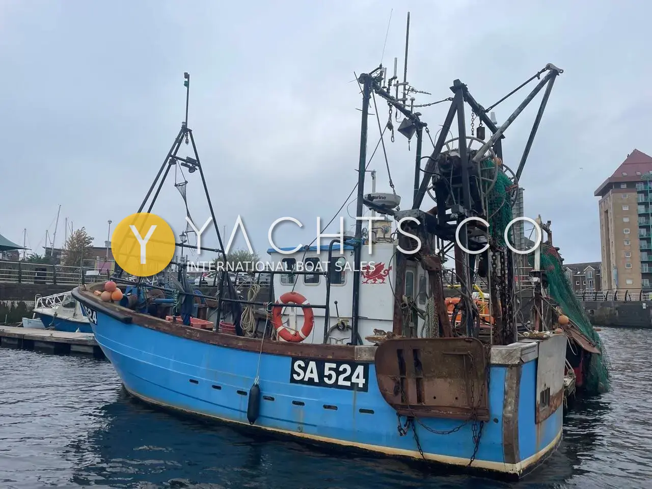 Cygnus Marine GM33: blue fishing vessel moored in harbour, showing wheelhouse, stern gantry and SA 524 registration