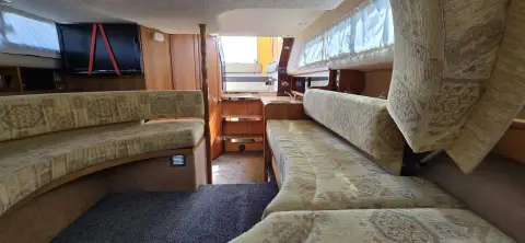 Draco 30: saloon with patterned upholstered seating either side and wood-panelled bulkheads
