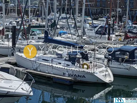 Dufour 36 Classic Owners Version: stern quarter view on pontoon showing name, sprayhood and outboard on pushpit