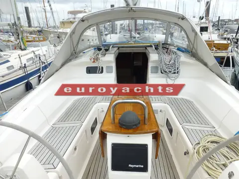 Elan Marine Impression 434: cockpit looking forward under the sprayhood, wooden table with plotter screen mounted at its aft end
