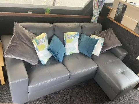 Fairline 40: new grey L-shaped saloon settee with blue and patterned scatter cushions