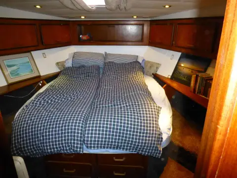 Fairline 50: forward owner's cabin with central island double berth and wood panelled lockers