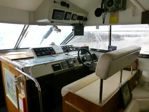 Fairline 50: lower helm station with wheel, instrument panel, overhead electronics and double seat