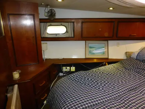 Fairline 50: owner's cabin side view showing opening portlight, overhead lockers and drawers beside berth