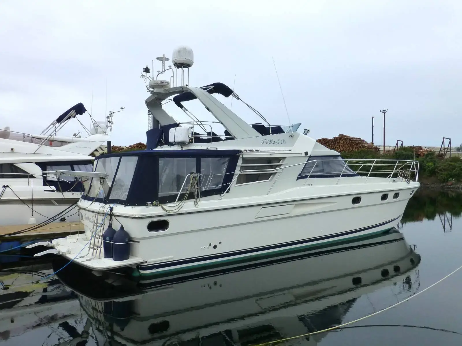 Fairline 50: exterior of the white and navy flybridge motor yacht moored at a pontoon with radar arch