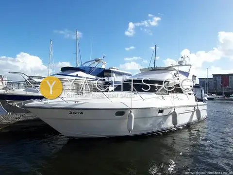 Fairline Phantom 41: starboard bow view of white flybridge hull moored in a sunny marina