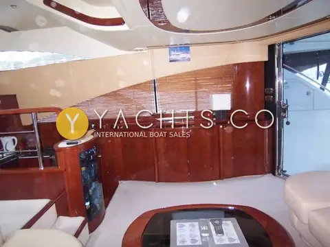 Fairline Squadron 58: saloon looking aft to cherry sideboard, blinds and open door to the cockpit