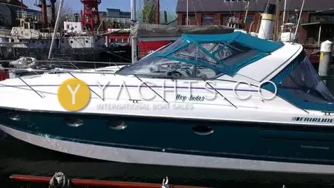 Fairline Targa 38: starboard profile in harbour beside a red lightship, showing 'Hey Jude!' name on topsides