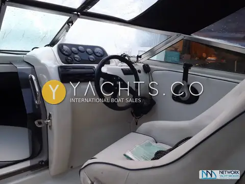 Fletcher 19GTS Sportcruiser: helm seat and steering wheel with grey upholstery and dashboard gauges under the canopy