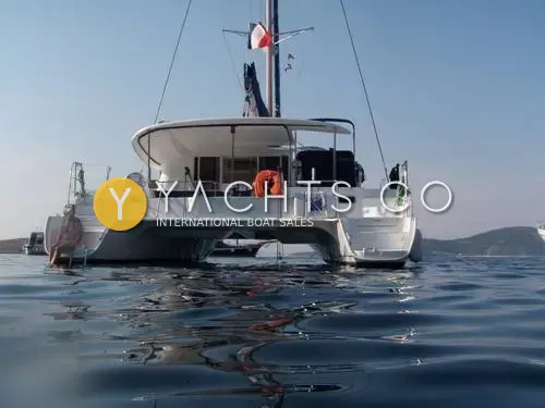 Fountaine Pajot Orana 44: stern view at anchor from water level, showing both hulls, transom steps and cockpit hardtop