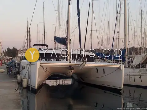 Fountaine Pajot Orana 44: bows and trampoline seen from the quay at dusk, reflected in still marina water