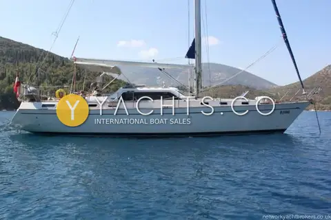 Franchini 45L: starboard profile at anchor showing centre cockpit, bimini and in-mast furling mainsail