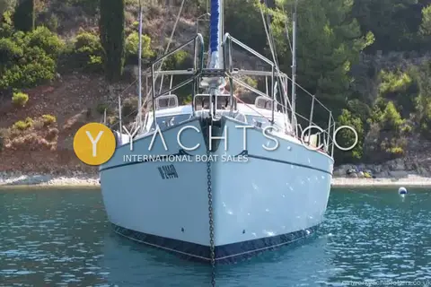 Franchini 45L: head-on bow view at anchor off a rocky wooded shore
