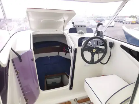 Galeon Galia 640 Timo: wheelhouse interior with open hatch down to forward cabin beside the helm and steering wheel