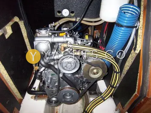 Gib Sea 37: engine bay with the three-cylinder diesel, belts and blue hose under the companionway steps