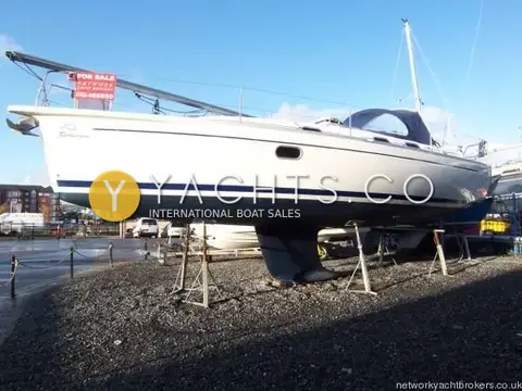 Gib Sea 37: port side of the white hull with blue stripe, ashore on stands in a Swansea boatyard