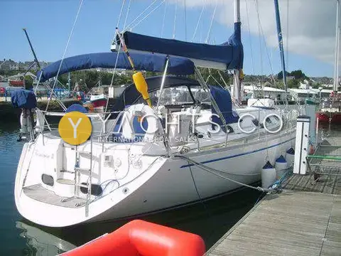 Gib Sea 43 Reduced: stern view moored on a pontoon with blue sprayhood, bimini and red tender alongside