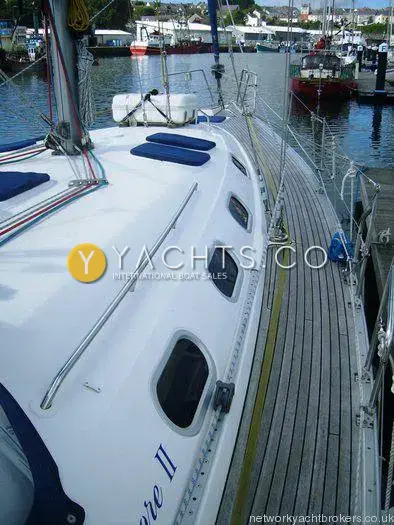 Gib Sea 43 Reduced: teak side deck running forward past coachroof portlights in a harbour marina