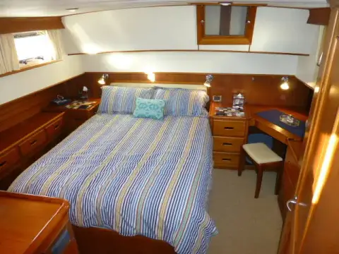 Grand Banks 42: aft owner's cabin with striped island berth, bedside drawers and vanity desk