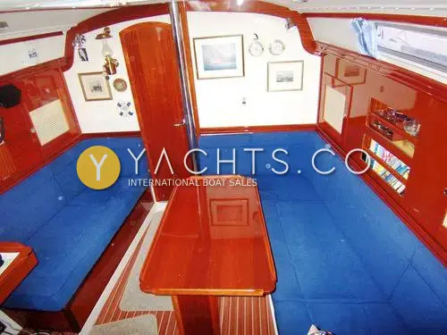 Hanse 341 Yacht For Sale: saloon from above with blue upholstered settees, high-gloss mahogany table and teak and holly sole