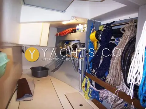 Hanse 341 Yacht For Sale: cockpit locker with rope storage, coiled lines on racks, shelf and yellow spotlight