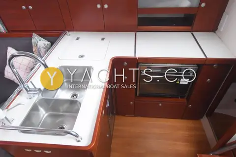 Hanse 370: galley with white worktops, double stainless sink, oven and wooden lockers