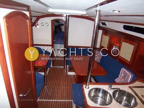 Hanse 411: saloon looking forward past twin galley sinks to blue U-shaped settee and forecabin