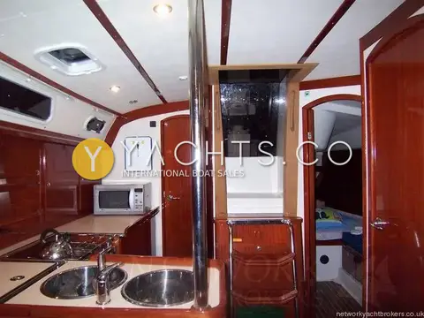 Hanse 411: galley and companionway steps, with an aft cabin door open beyond