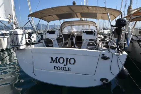 Hanse 505: transom showing name and Poole home port, twin wheels under the bimini