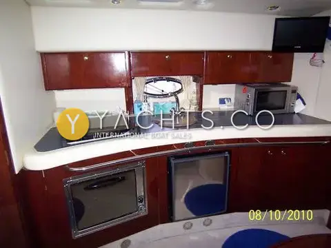 Hardy Marine Seawings 355: linear galley with dark worktop, hob, sink, microwave, oven and fridge under cherry cabinets