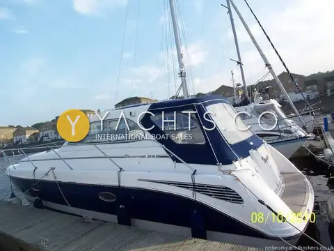 Hardy Marine Seawings 355: starboard quarter view at a marina pontoon, navy hull with canopy fitted
