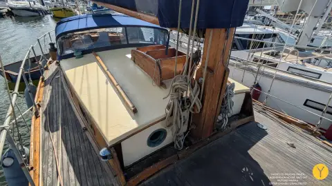 Hillyard 12 Ton: varnished coachroof with mast in tabernacle and halyards coiled on the deck