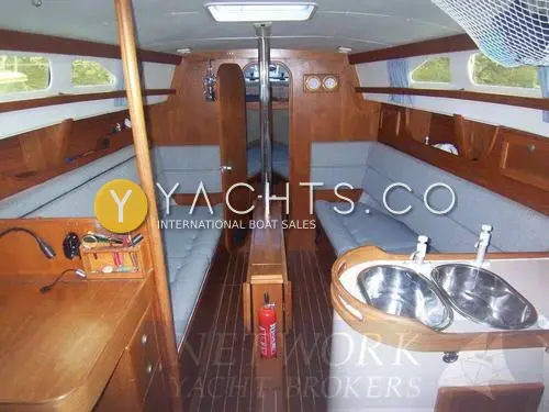 Hunter Channel 32: saloon looking forward past twin galley sinks to blue settees and central folding table