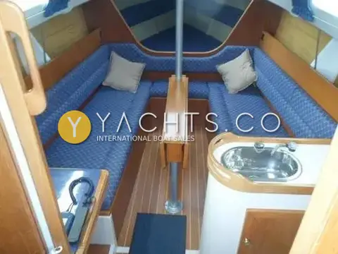Hunter Ranger 265: saloon from companionway with blue upholstered seating, folding wooden table and view into forecabin