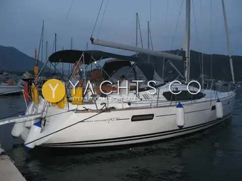 Jeanneau 42 DS: starboard side at dusk in a marina, Sun Odyssey 42 DS lettering on the hull